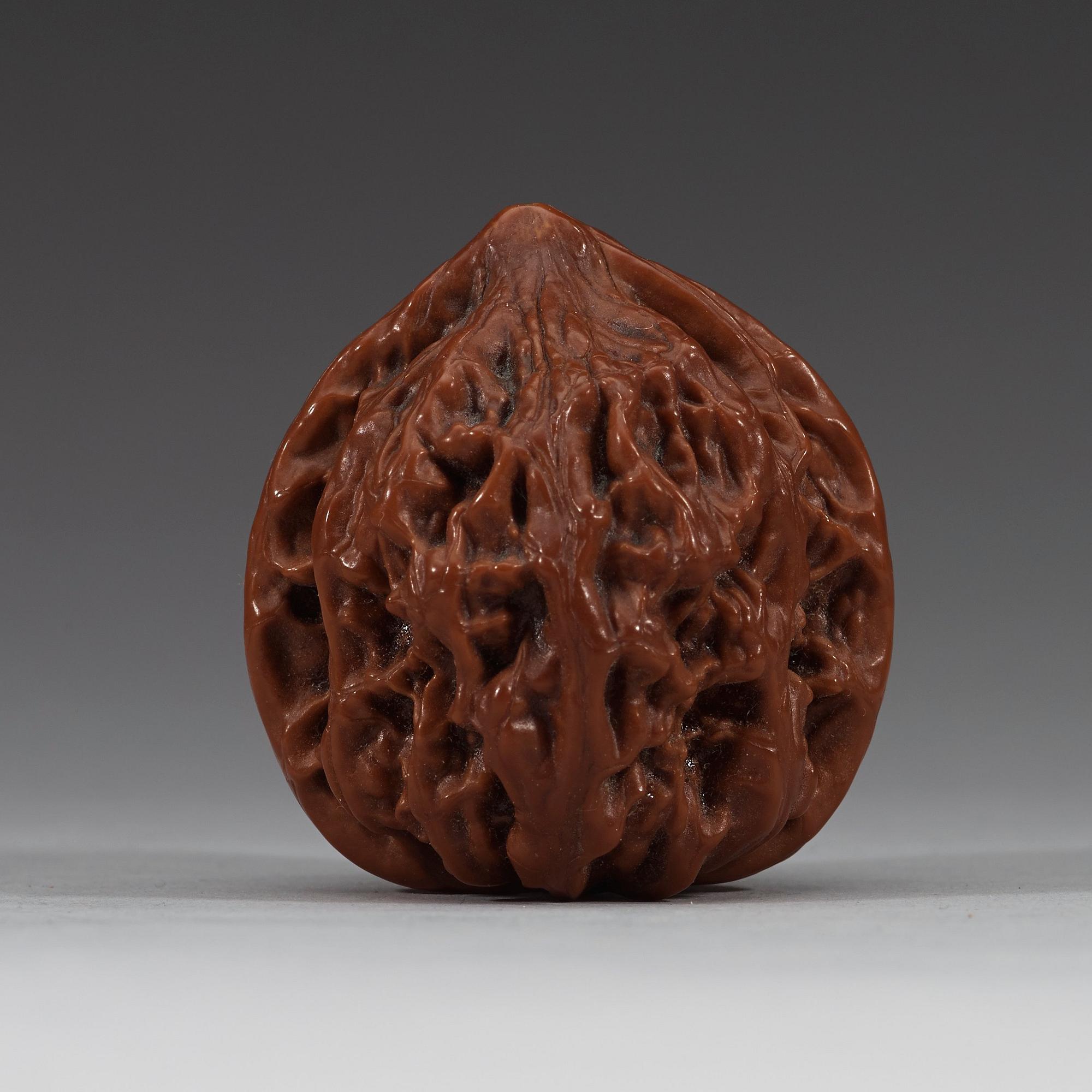 Two pairs of carved walnut hand exercisers, late Qing dynasty (1644-1912).