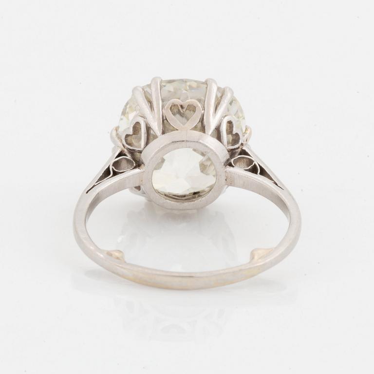 A platinum ring set with a cushion-formed old-cut diamond.