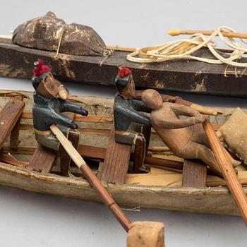 AN UMIAK AND THREE KAJAKS, MODEL BOATS GREENLAND, WITH FIGURES, PADDLES, SPEERS ETC.