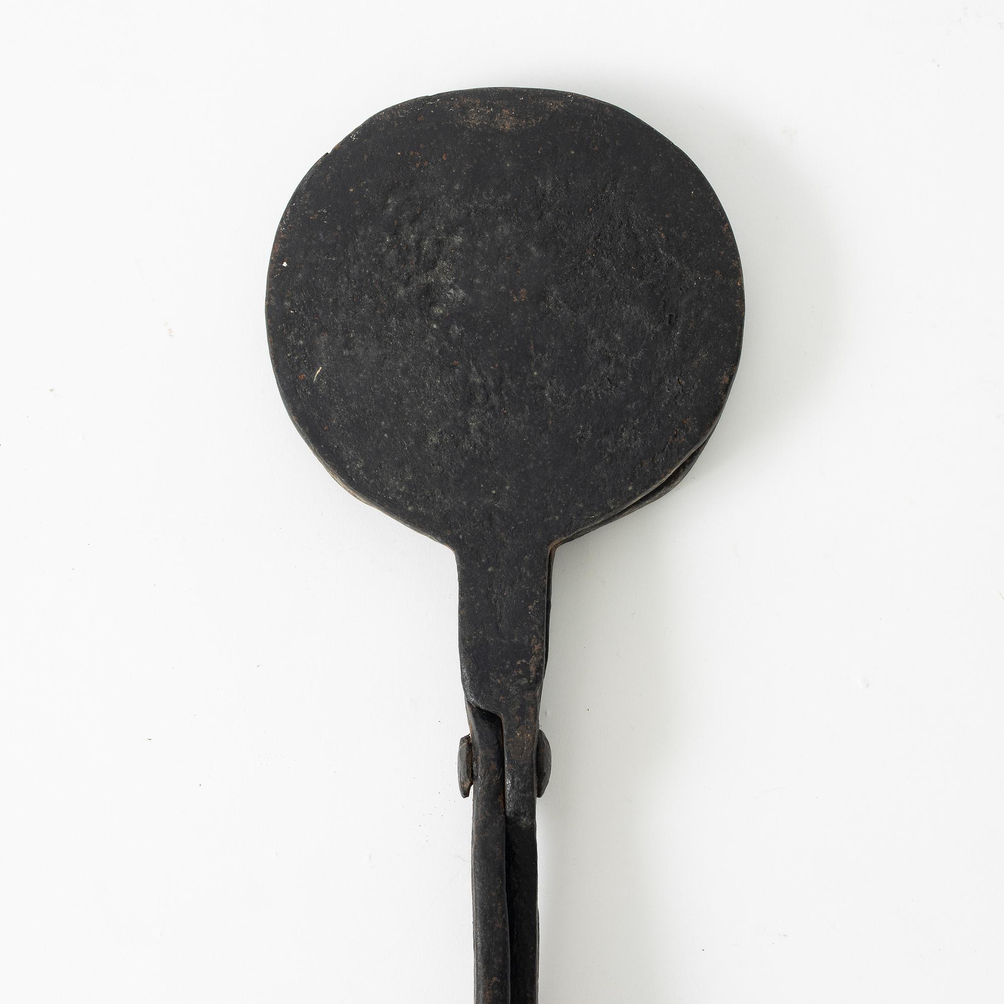 An iron wafer maker, dated 1662.