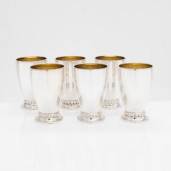 A set of six vodka cups, five napkin rings, a champagne whisk, and a tong, silver, Turku and Hämeenlinna, 1938, 1970.