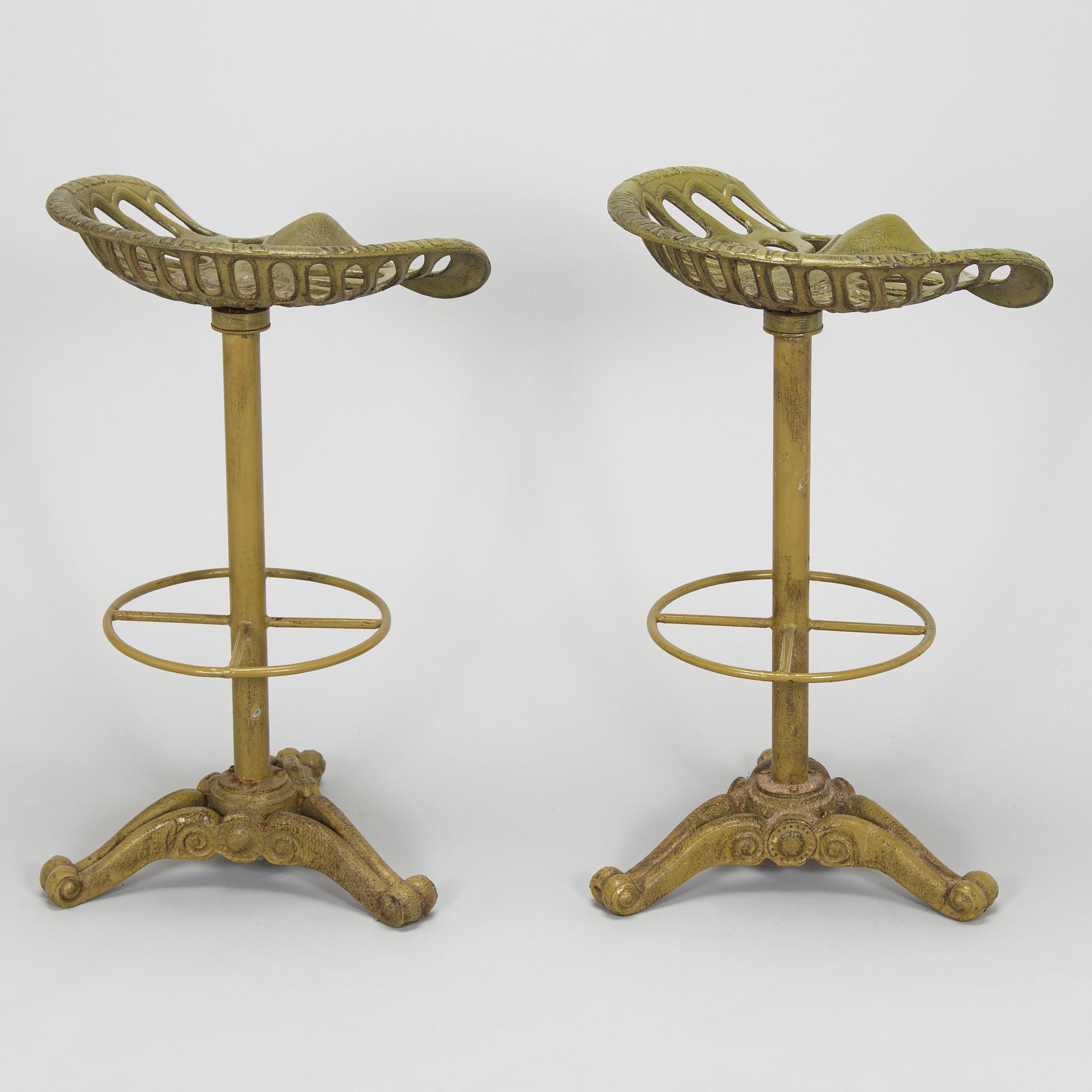 Four bar stools, painted cast iron, partly from the early 20th century.