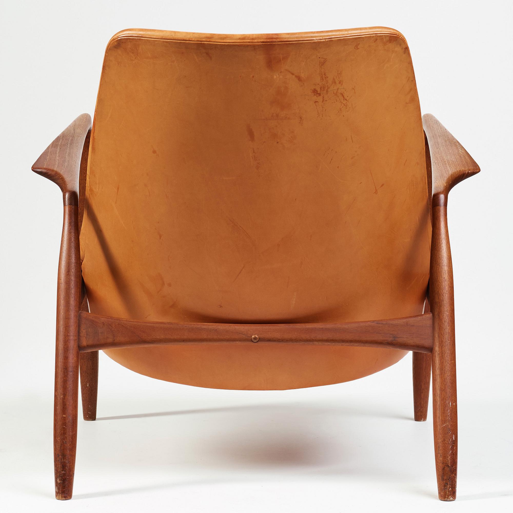 Ib Kofod-Larsen, a "Seal" teak and brown leather armchair, Olof Persson Möbler, Jönköping, Sweden 1950-60's.