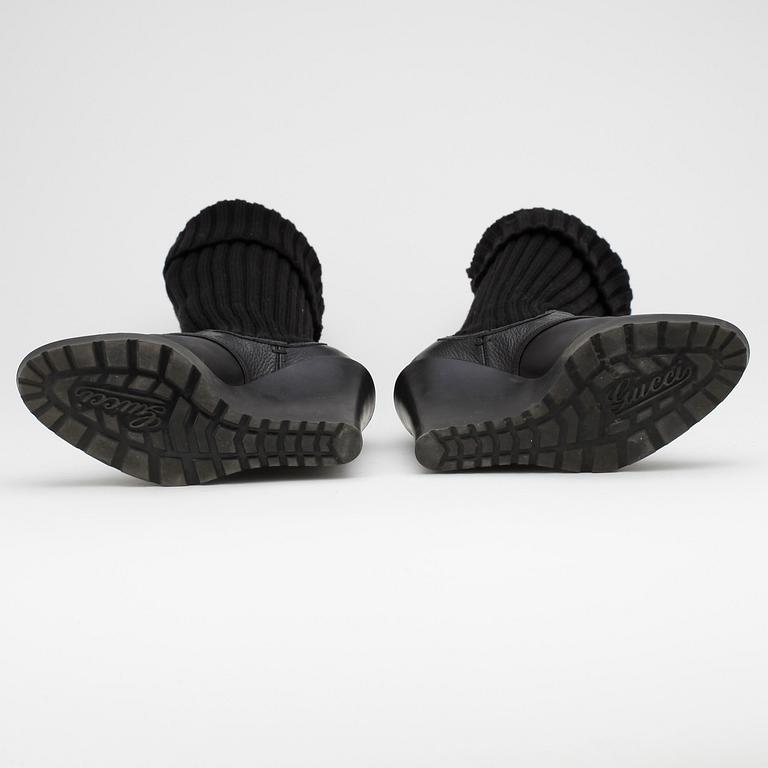 GUCCI, a pair of black leather boots.