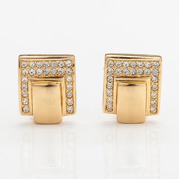 Christian Dior, A pair of gold coloured metal earrings with rhinestones. Marked Chr. Dior, Germany.