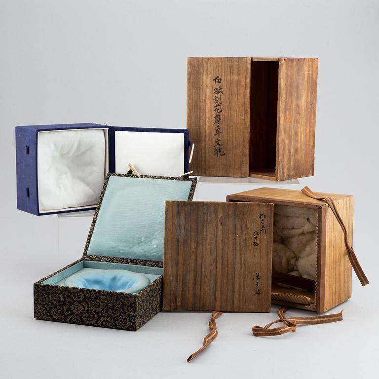 A set of seven Chinese and Japanese boxes, wood or textile clad, 19th/20th Century.