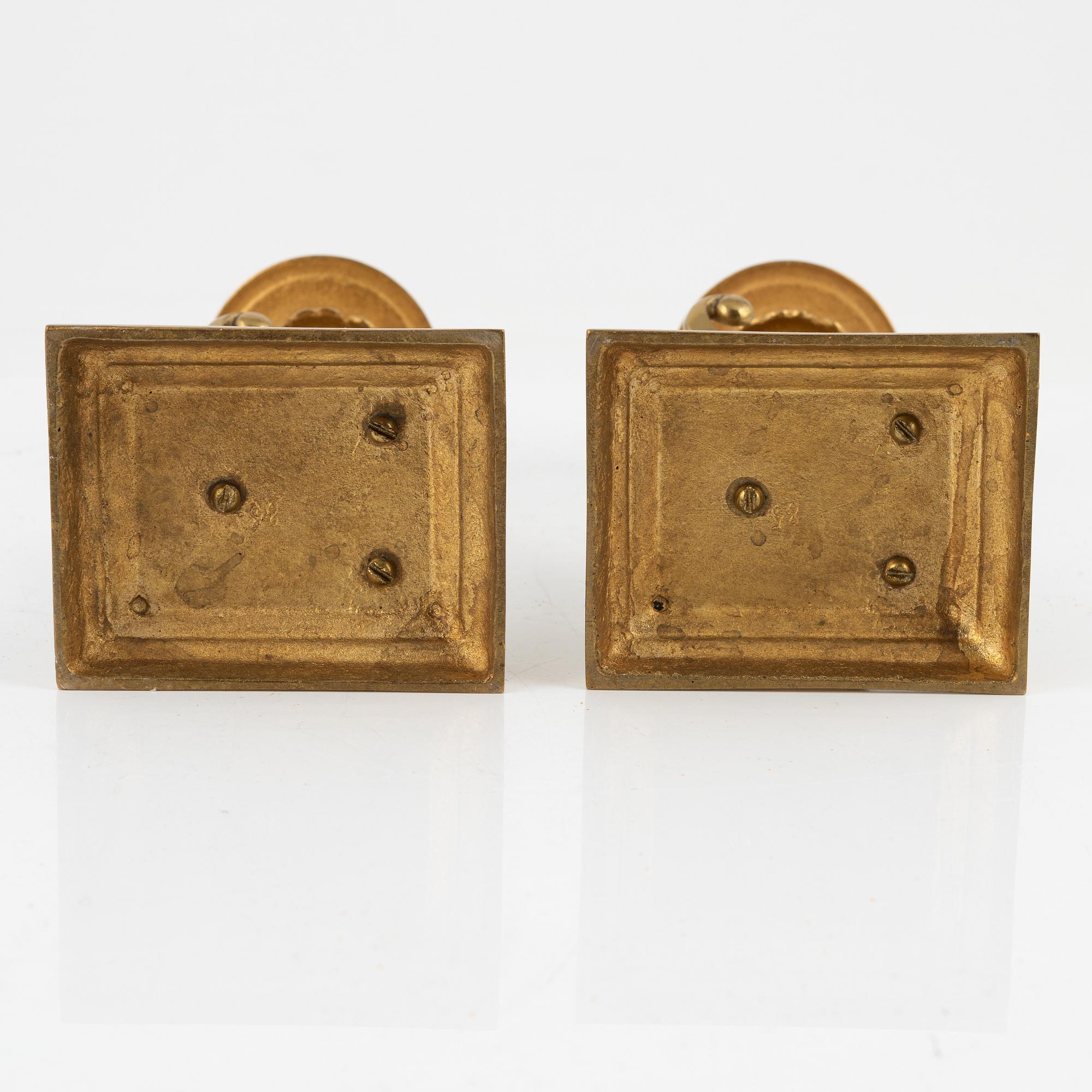 A pair of brass candleholders, 20th century.