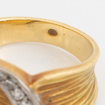 An 18K gold ring set with eight-cut diamonds.