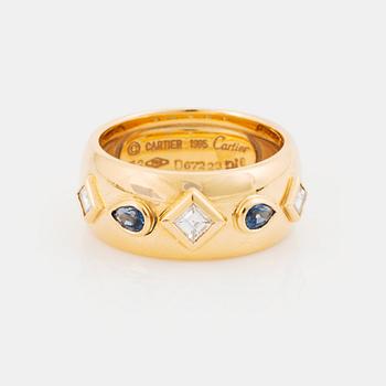 470. An 18K gold Cartier ring set with step-cut diamonds and faceted sapphires.