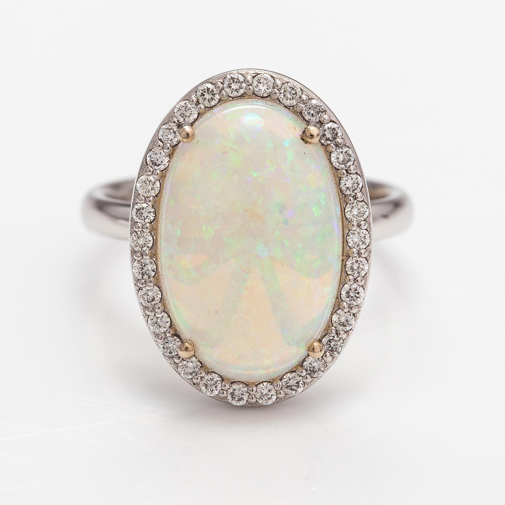 An 18K white gold ring with an opal ca. 4.64 ct and diamonds ca. 0.35 ct in total according to certificate.