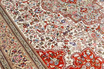 A carpet, figural Tabriz, so-called Tabatabai, approx. 380 x 282 cm.