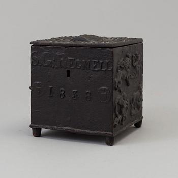 An empire cast iron tobacco box, dated 1838.