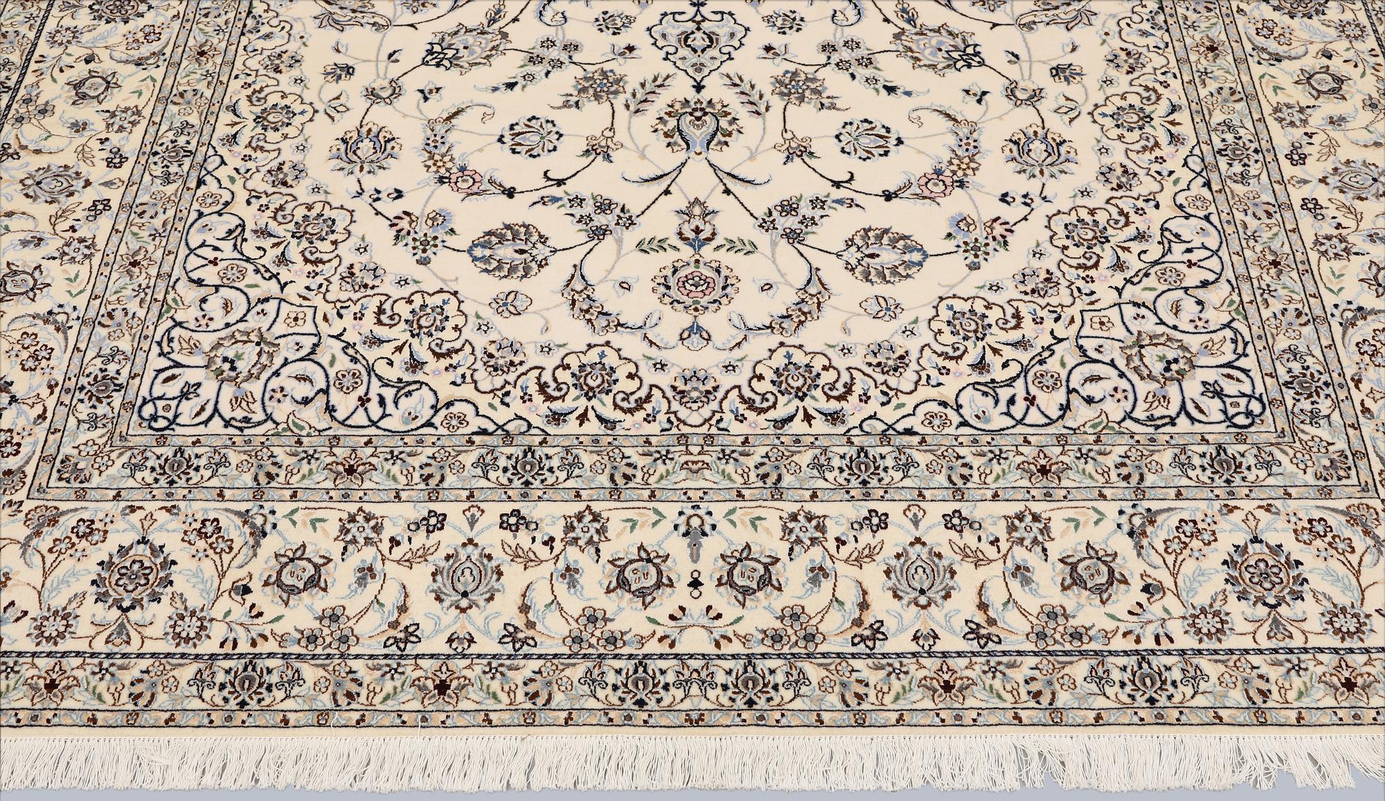 A Nain, part silk carpet, 305 x 207 cm.