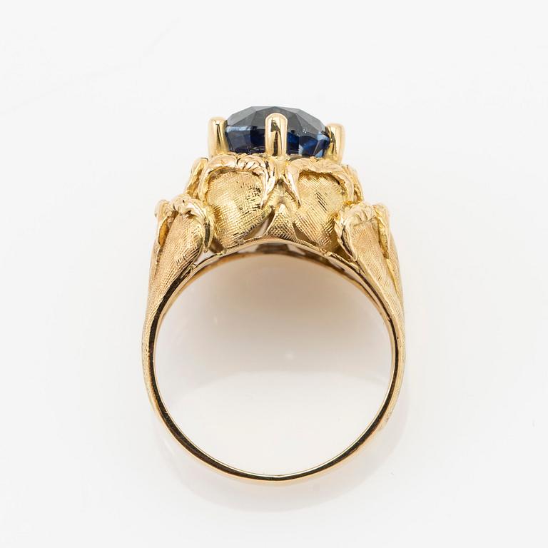 Ring, 18k gold with blue stone, possibly sapphire.