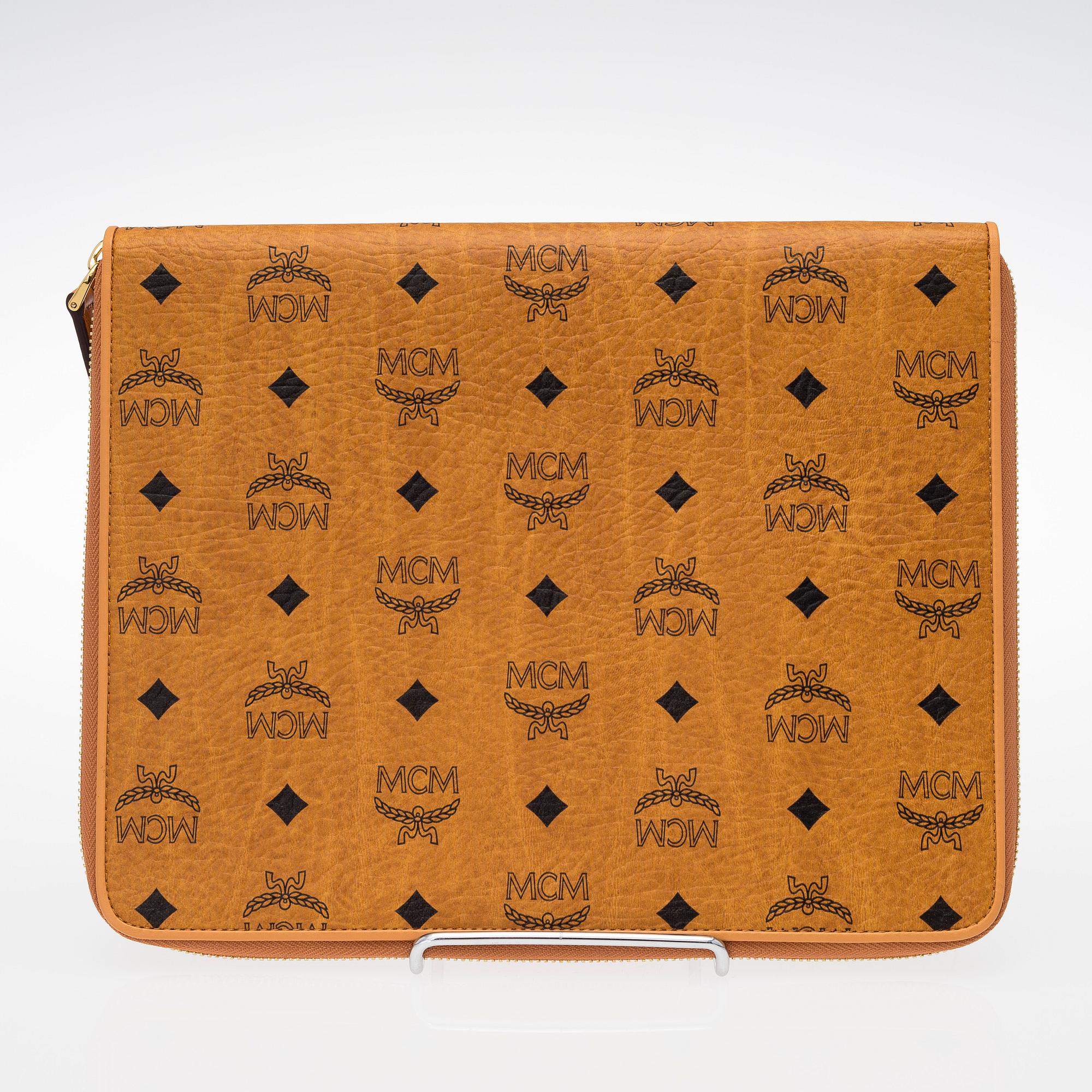 An MCM Heritage iPad and card case in leather. Bukowskis