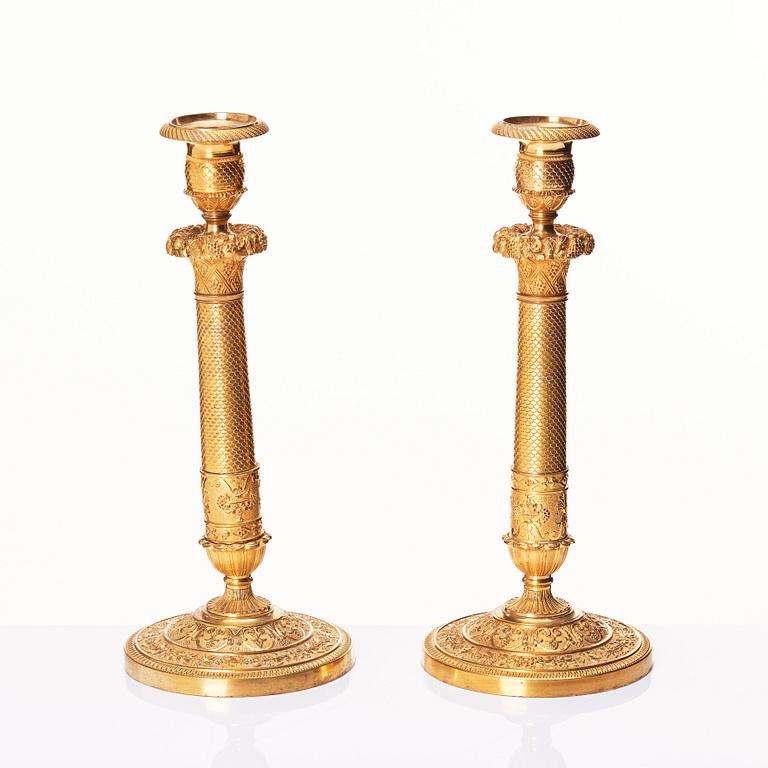 A pair of French gilded Empire candlesticks, early 19th century.