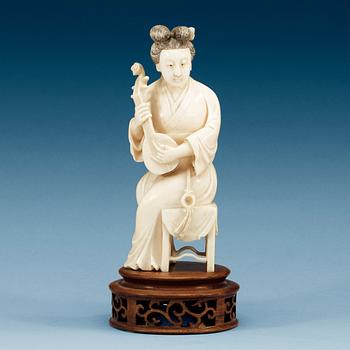 1608. A ivory sculpture of a female musician, late Qing dynasty (1644-1912).