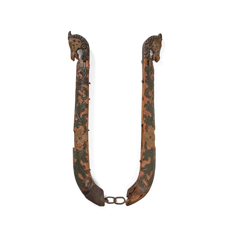A pair of Swedish folk art carved and polychrome painted horse harness parts, Hälsingland, 18th century.