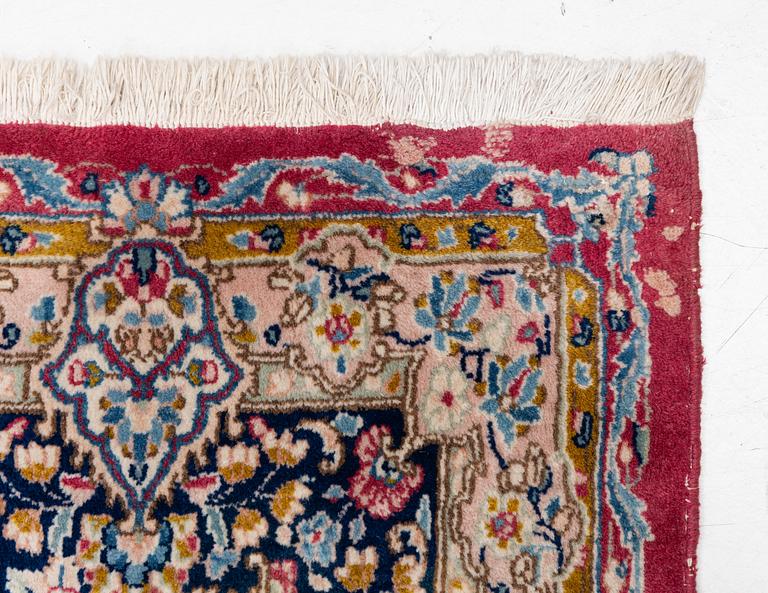 A Kirman carpet, signed, c. 388 x 279 cm.