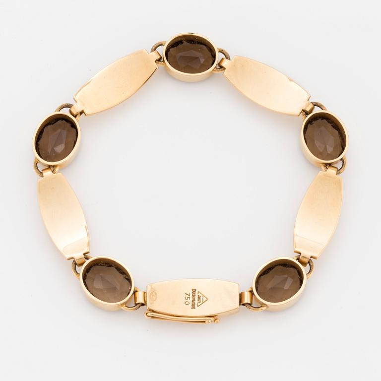 A Just Andersen 18K gold and smoky quartz bracelet.