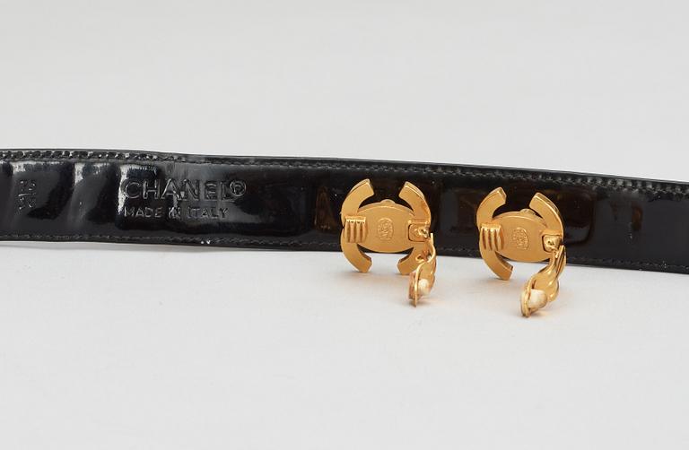A pair of erclips and a belt by Chanel.