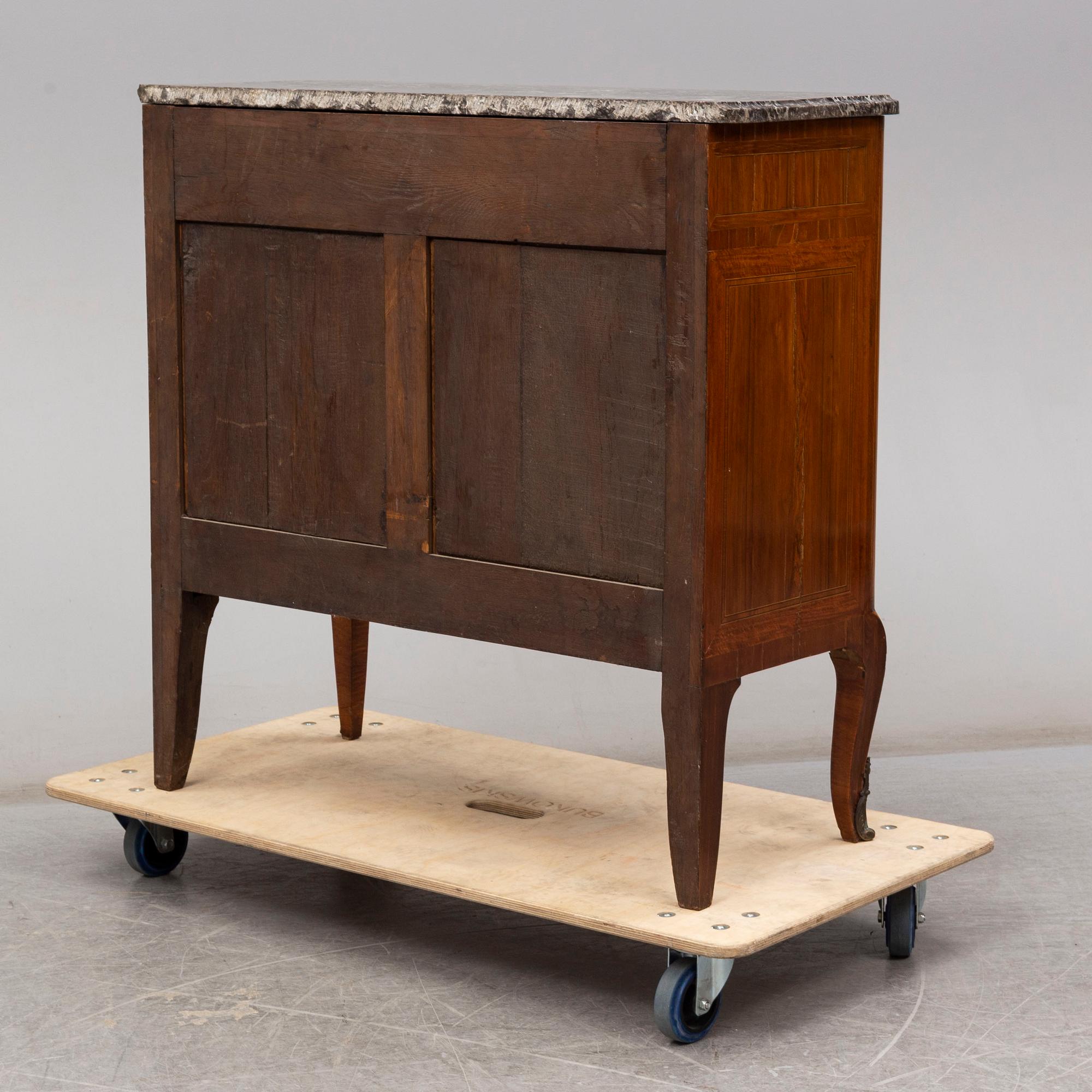 A French Louis XVI-style cupboard, ca 1900.