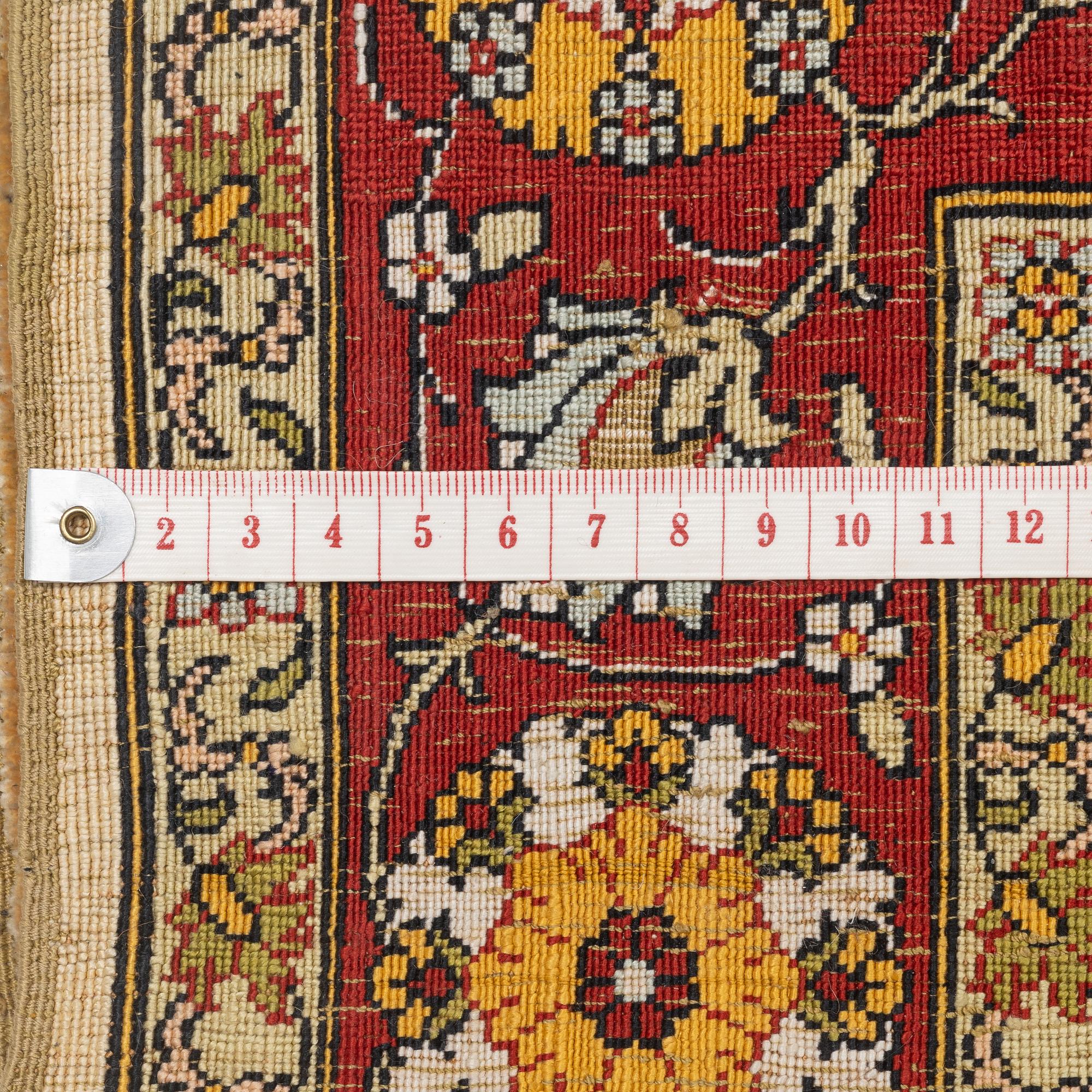 A silke rug, Hereke, signed, c. 90 x 61 cm.