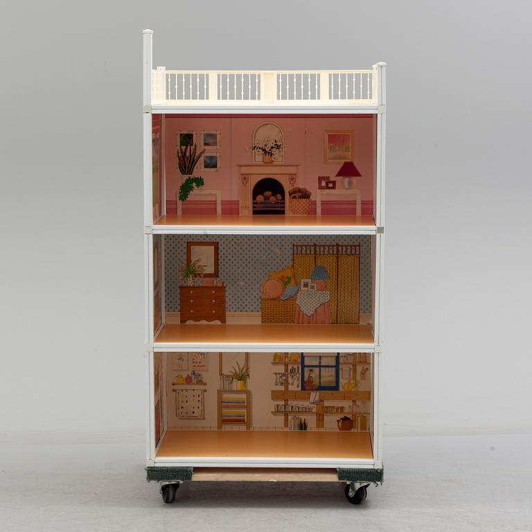 A plastic doll's house with six dolls, furniture and clothes, 20th century.