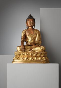 A finely cast Tibeto-Chinese gilt bronze figure of Shakyamuni Buddha, Qing dynasty, circa 1800.