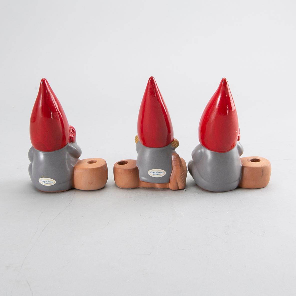 LISA LARSON, a set of three candle sticks.