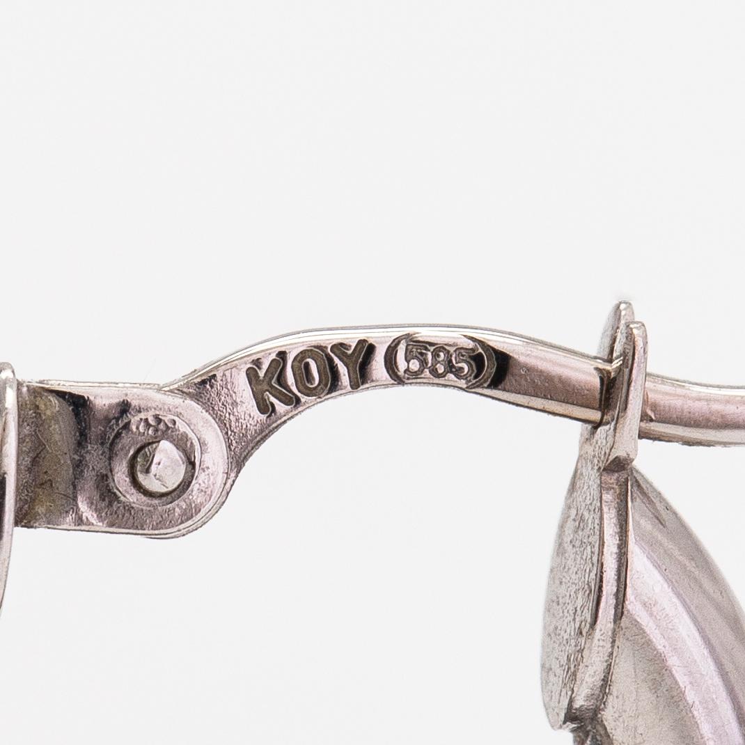 A pair of 14K white gold earrings.