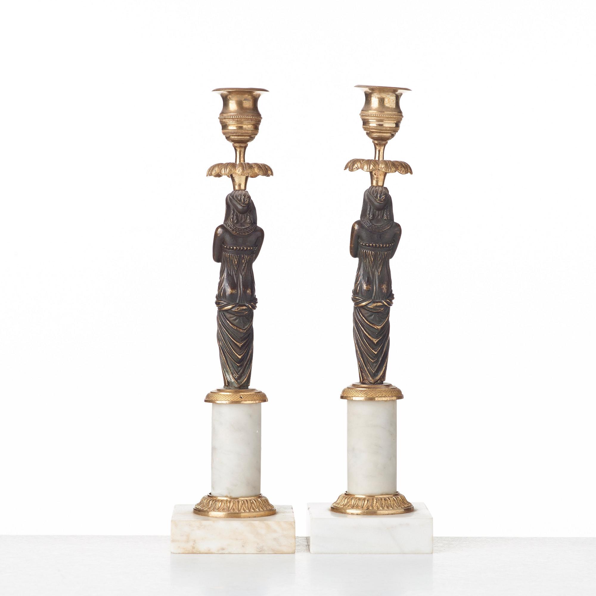 A pair of late Gustavian circa 1800 white marble and bronze candlesticks.