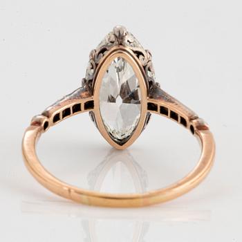 A 14K gold and silver ring set with a navette-cut diamond with a total weight of ca 2.75 cts quality ca K vs.