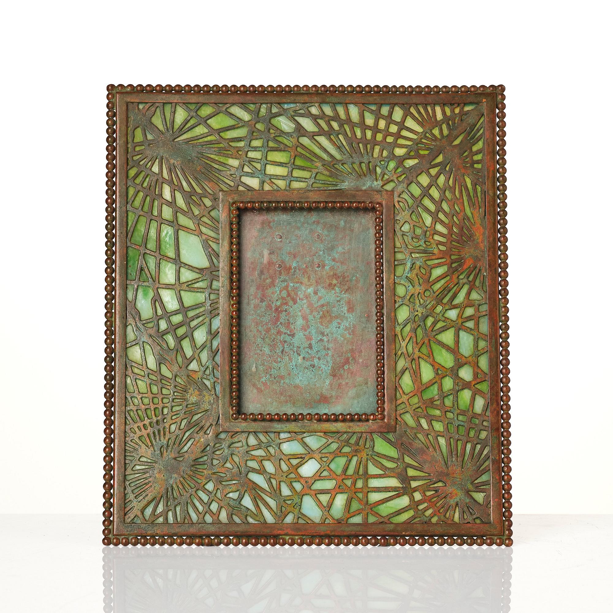 Louis Comfort Tiffany / Tiffany Studios, an Art Nouveau bronze and marbled "Pine needles" glass frame model "948", New York.