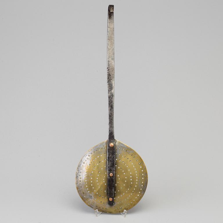 An 18th century iron and brass strainer.