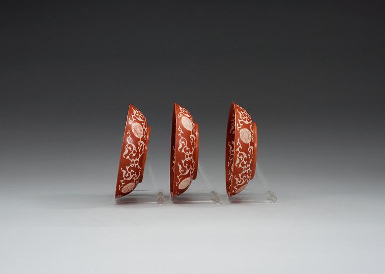 A set of three coral red dishes, Qing dynasty, with Daoguang seal mark.