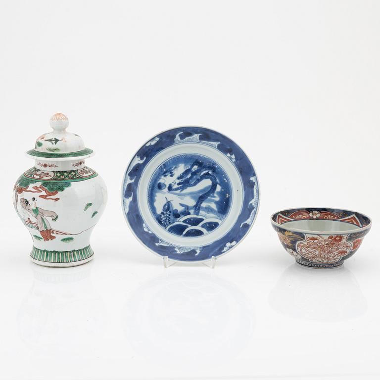 A Chinese dinner plate and a Japanese imari bowl, 18th Century together with a Chinese 19th Century jar with cover.