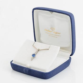 An 18K white gold necklace with a faceted sapphire.