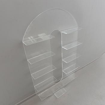 Shelf, plexi glass, in the shape of the letter 'O',Non Violence.