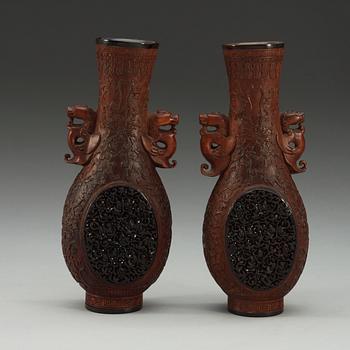 A pair of carved wooden and tortoise shell inlayed vases, presumably late Qing dynasty (1644-1912).