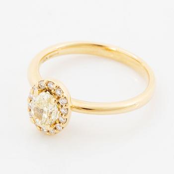 Oval light yellow diamond and brilliant-cut diamond ring.