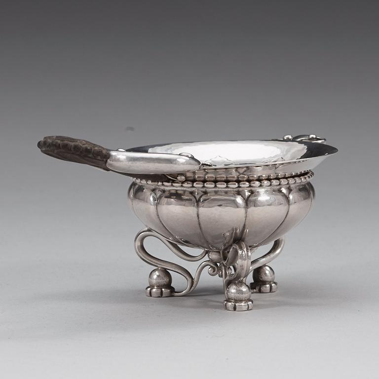 A Georg Jensen tea-strainer with stand, Copenhagen ca 1915-21.