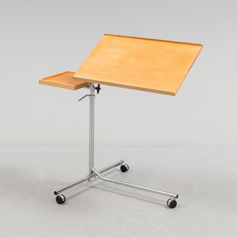 A teak reading table, second half of the 20th Century.