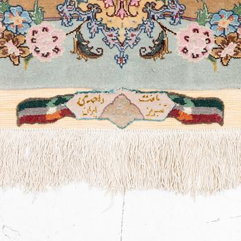 A Tabriz carpet, part silk, approx. 367 x 250 cm.