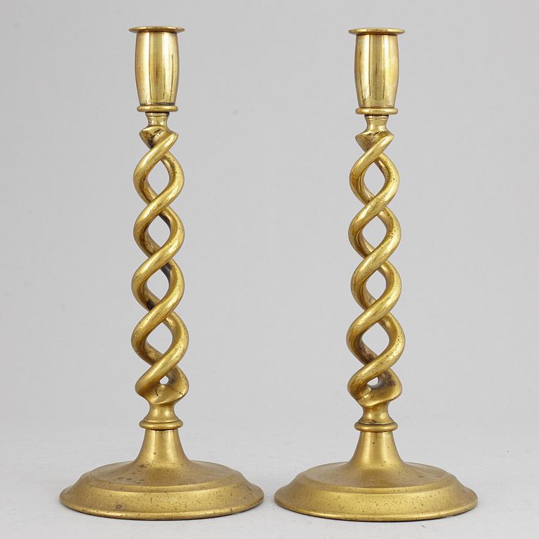 A pair of brass candle sticks. possibly English, circa 1900.