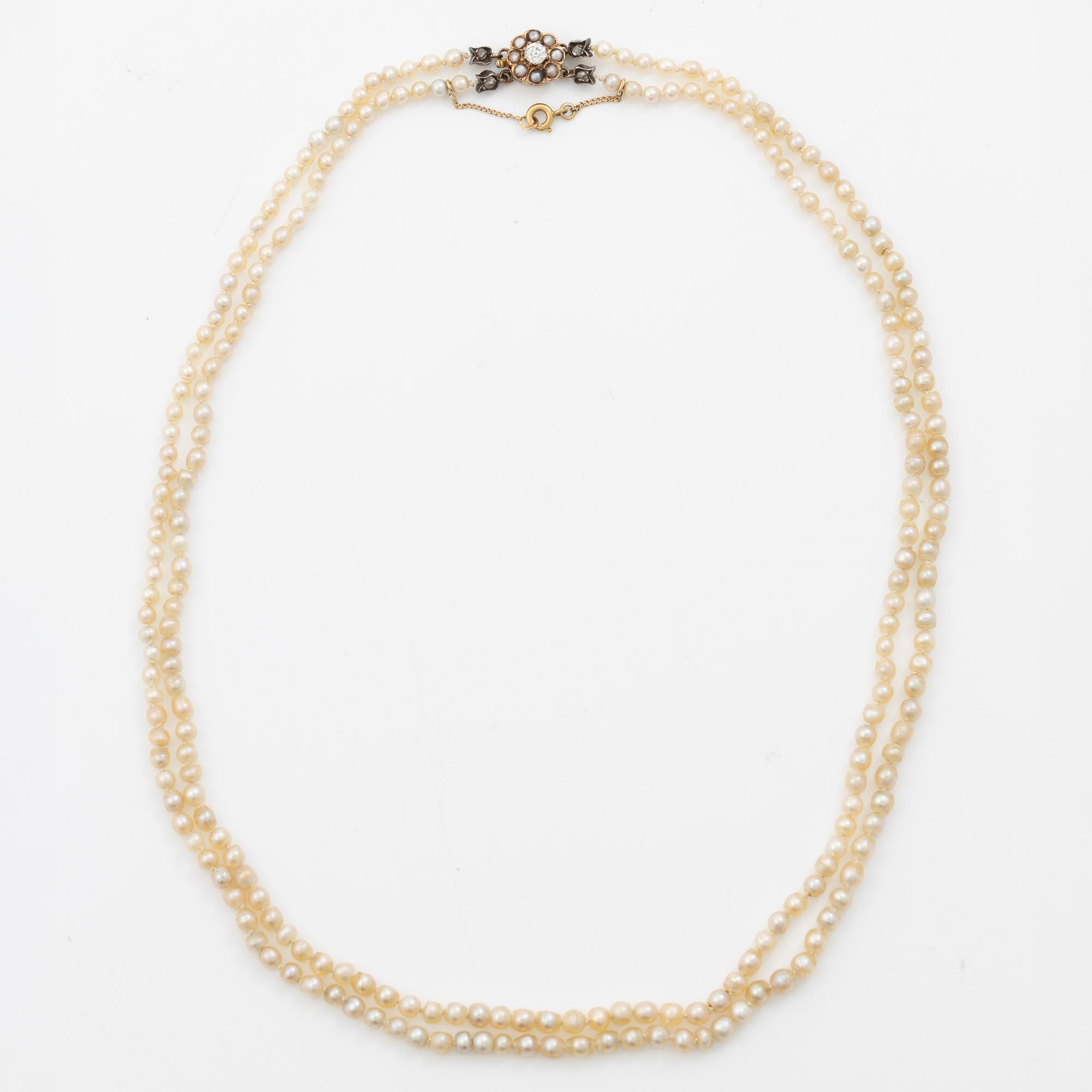 Pearl necklace with a gold clasp set with an old-cut and rose-cut diamonds and pearls.