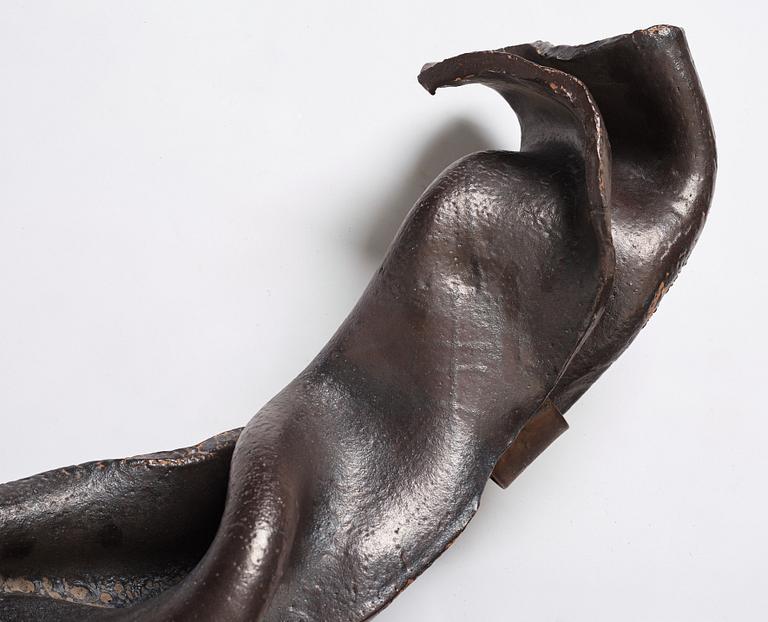 Hertha Hillfon, a black glazed stoneware wall sculpture in two parts of a face and a sky, executed in her own studio, Stockholm 1960s.