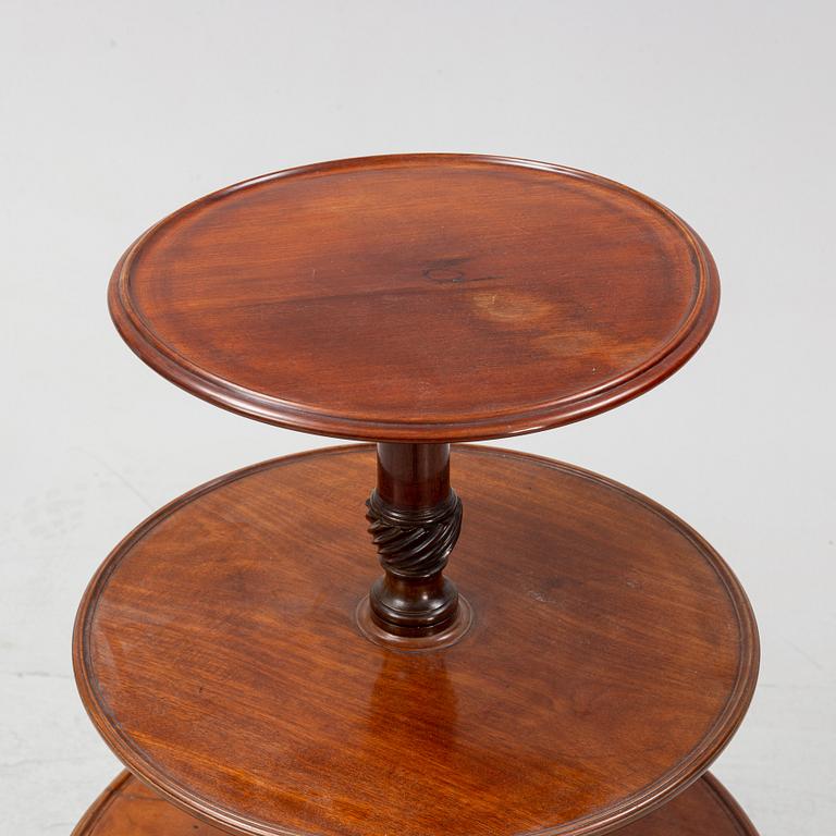 A mahogany three-tier table, England, circa 1900.