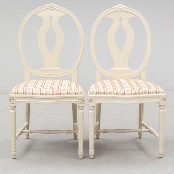 A set of eight chairs and a dining table. Gustavian style, second half of the 20th century. 2 leaves included.