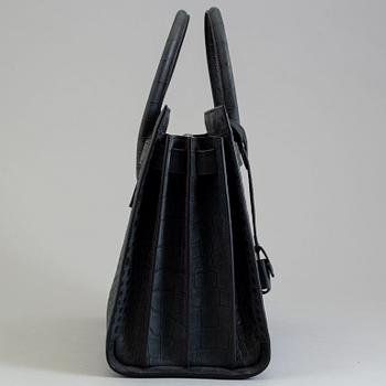 A bag by Yves Saint Laurent, "Sac du jour".